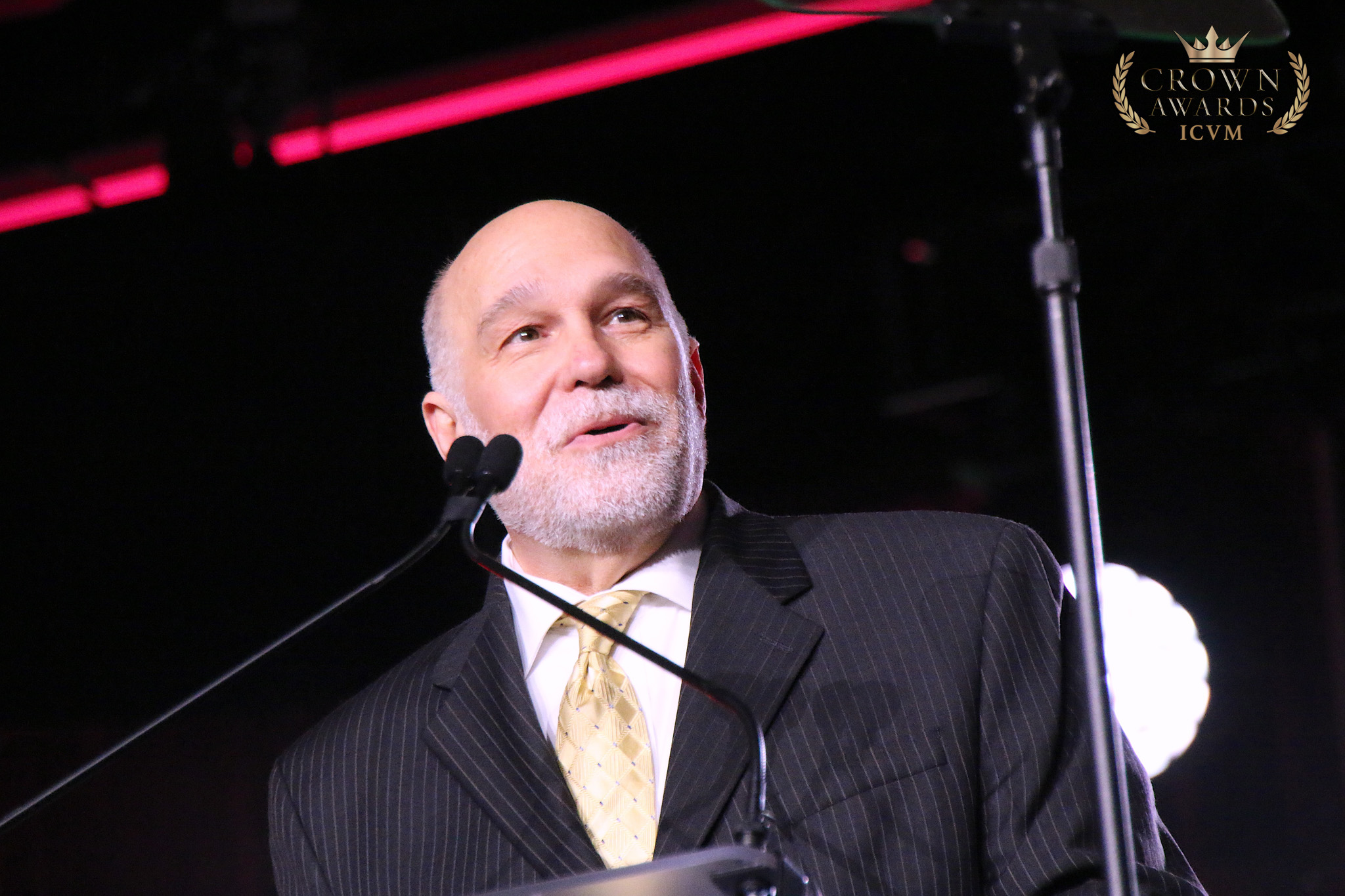 A Crown Awards presenter speaking at the podium