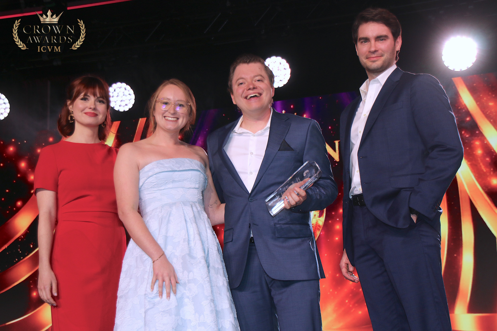 Four production team members posing with a Crown Award