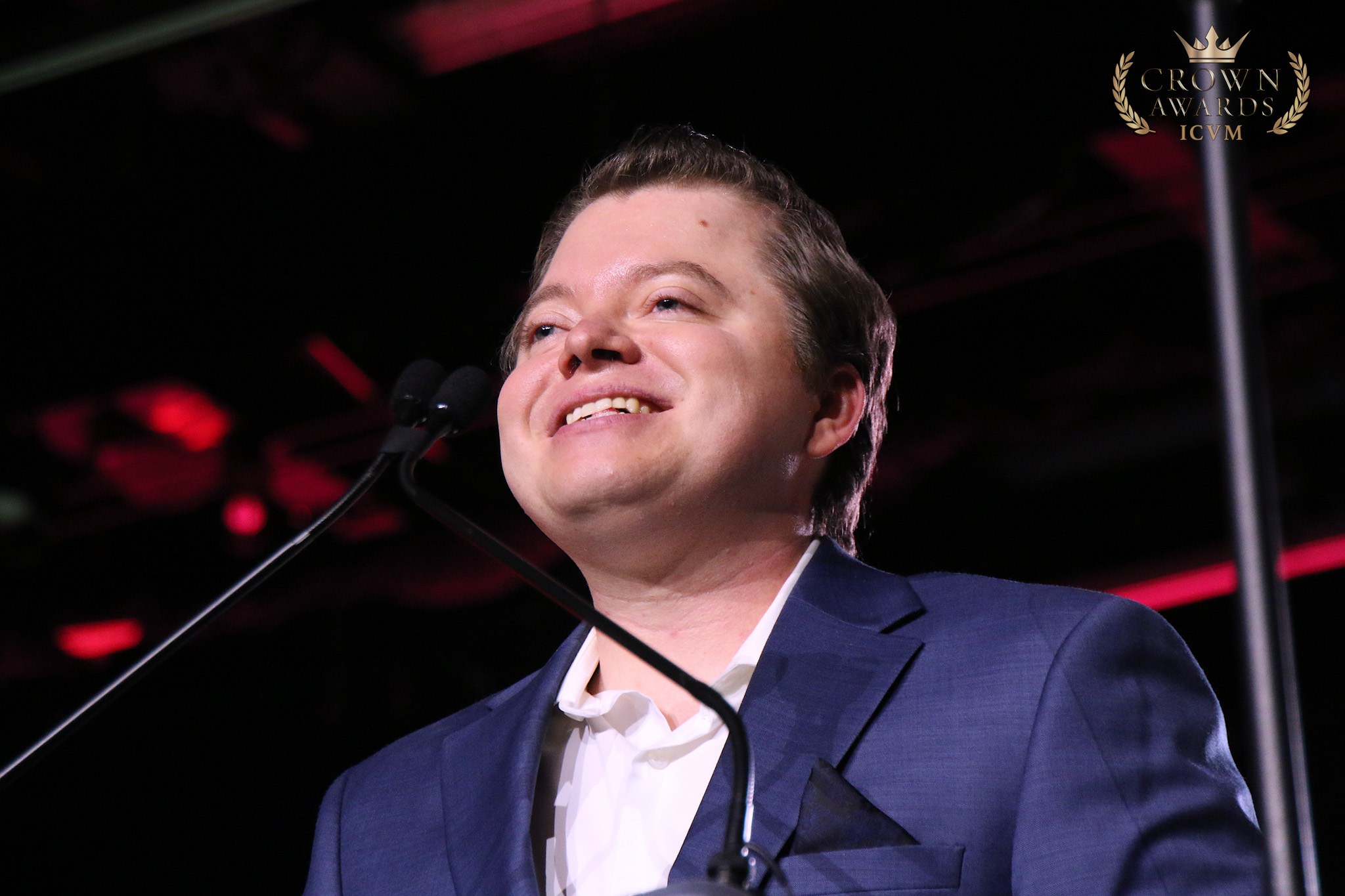A Crown Award recipient delivering remarks at the podium