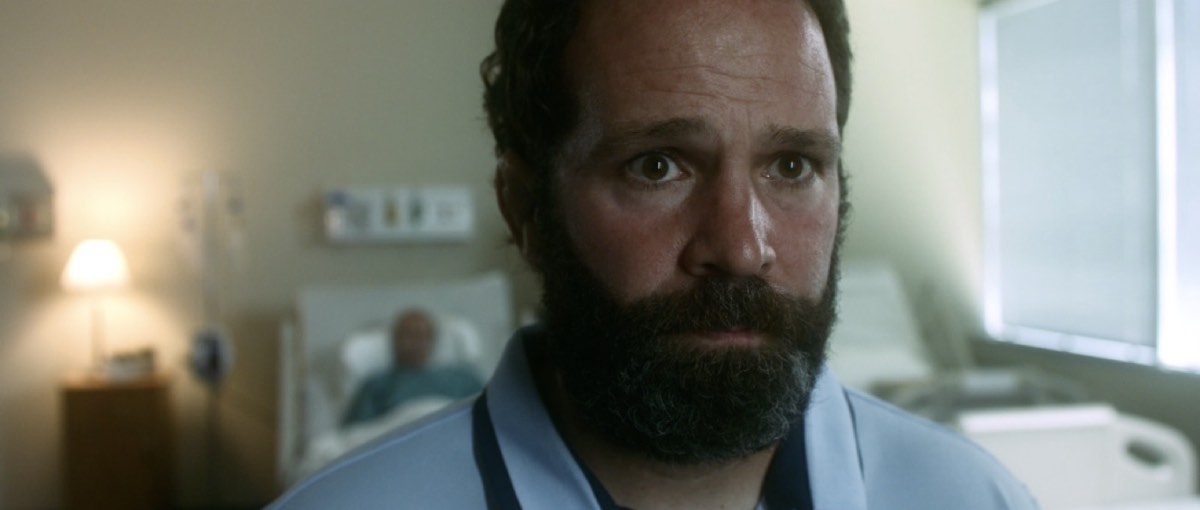 Marc Lucia portraying Mark in a hospital scene from Forgiving the Nightmare